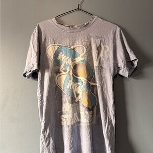 Vintage-Style Light Lavender Graphic Tee with Blue & Yellow Print